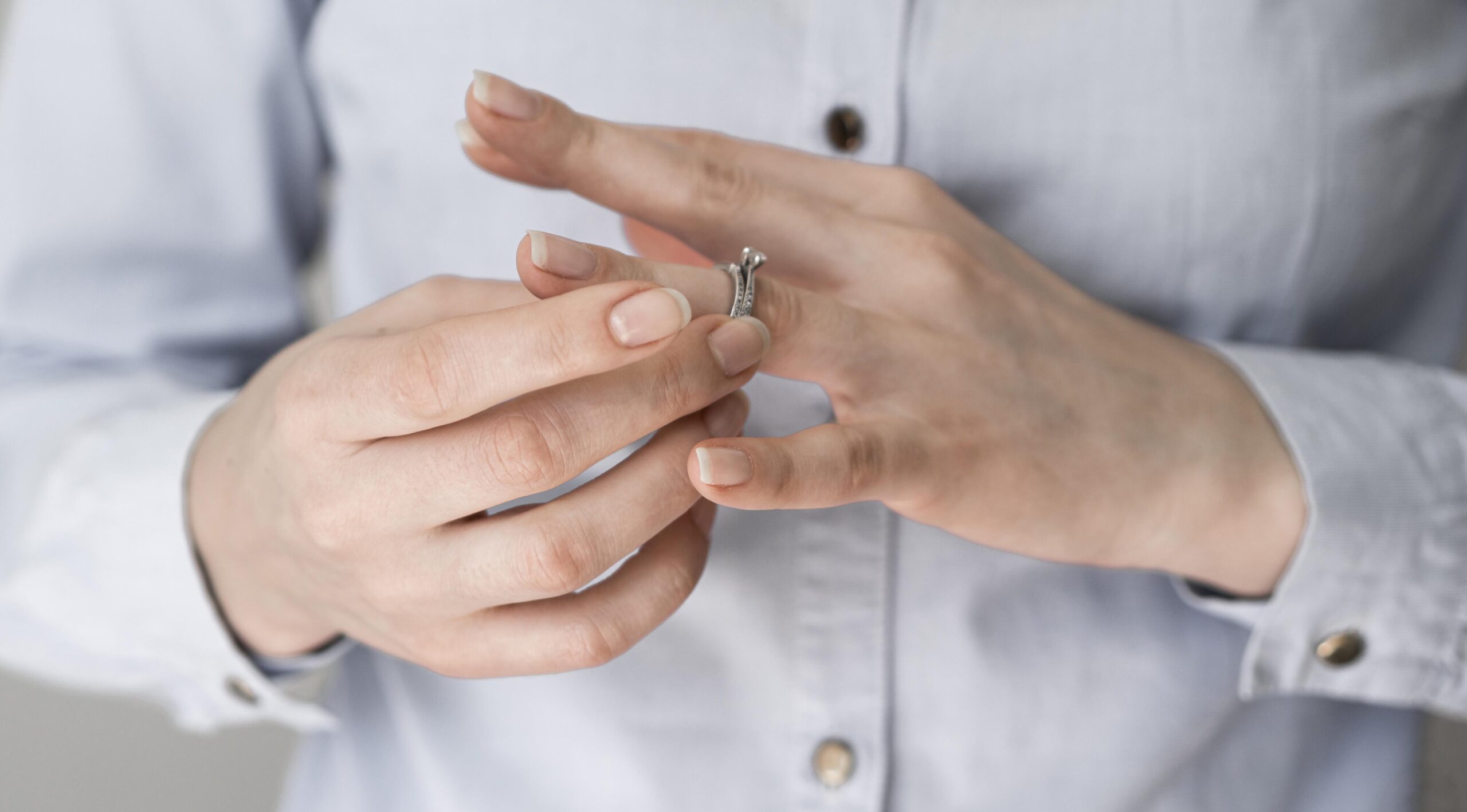 woman pulling off marriage ring scaled